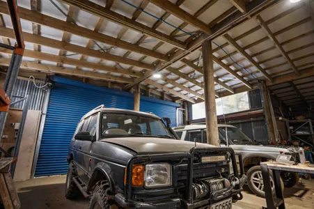 Vehicles parked in a large workshop shed built by Greenfield Construction