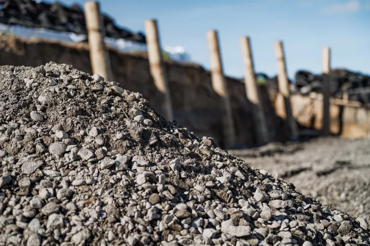 Pile of gravel being used for groundworks on a residential section to create a retaining wall