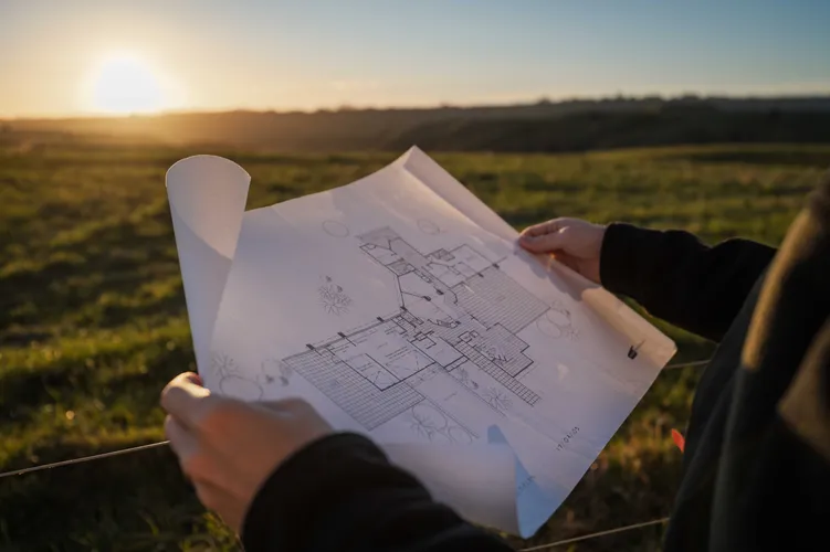Holding up new house plans for a new build on a Manawatu property