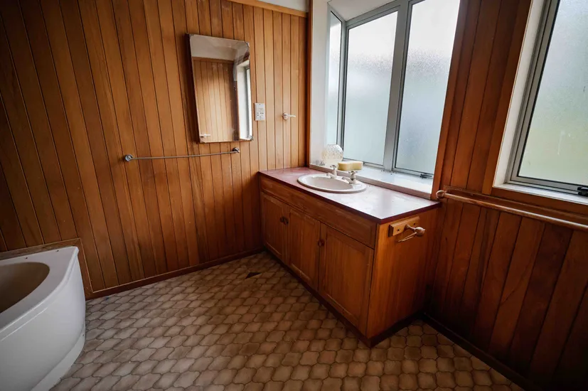 This bathroom in an older house had cracked window sill and leaking taps, Greenfield Construction repaired the issues in this bathroom