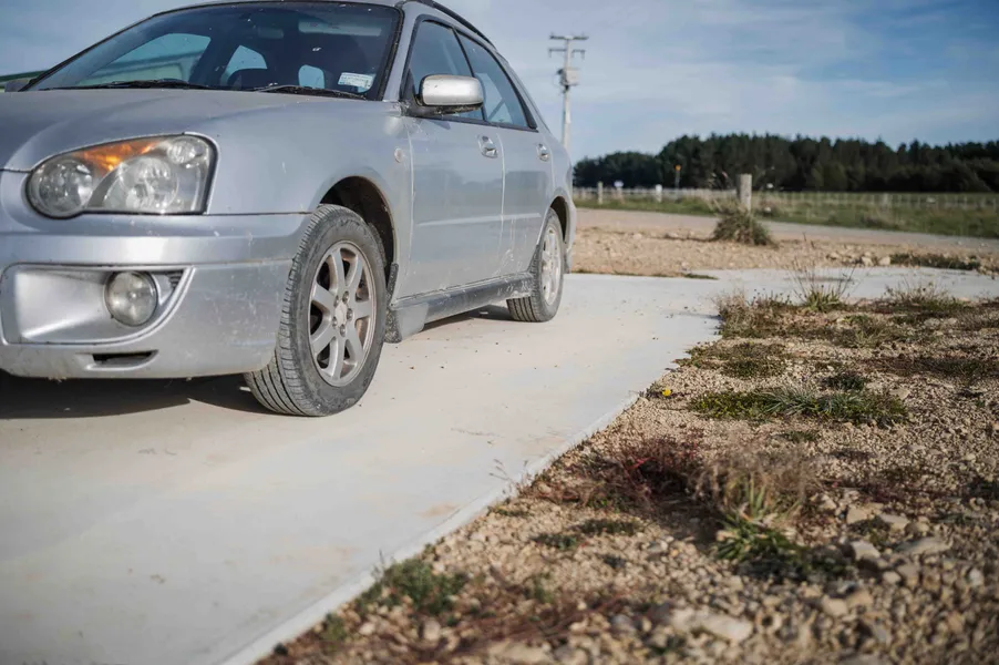 Car parked on new concrete driveway and car port area for easy access in wet season