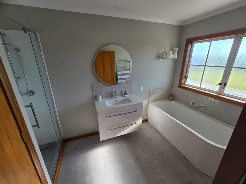 Bathroom refreshed, including a shower replacement, new sink and new bathtub