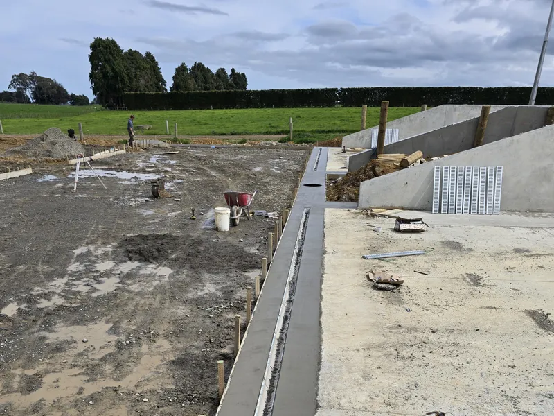 Drainage channels to collect effluent waste from silage stack runoff