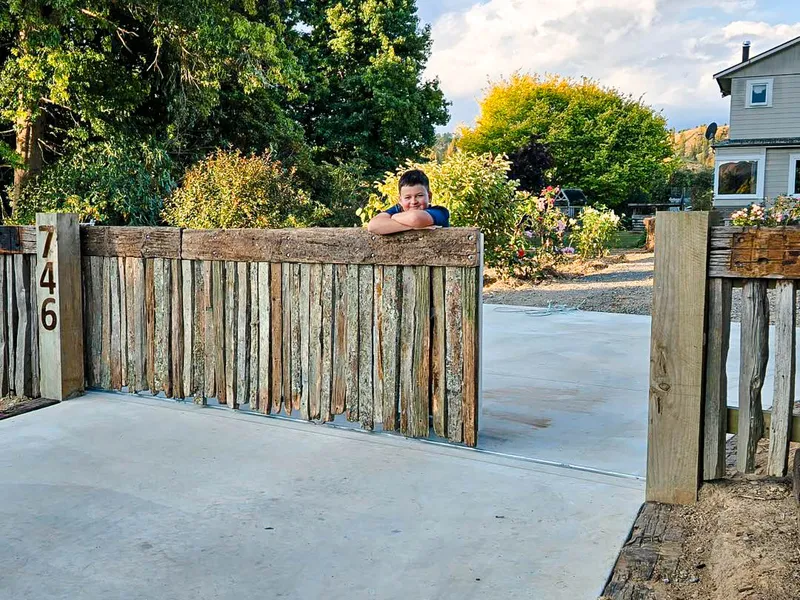 New gate made of old fence battens and fence to match and concrete driveway