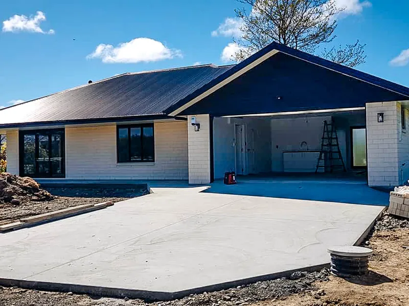 New home build construction with a concrete driveway and brick exterior