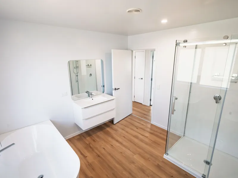 Bathroom of a new house, with shower, bath, sink and toilet