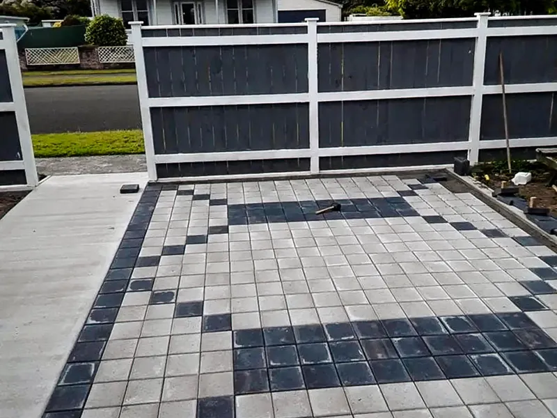 Paved garden area with a pattern and concrete to connect the garden beds