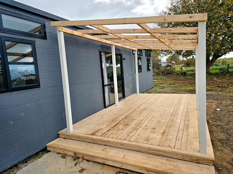 Covered area being built outside door to protect entrance from wet weather