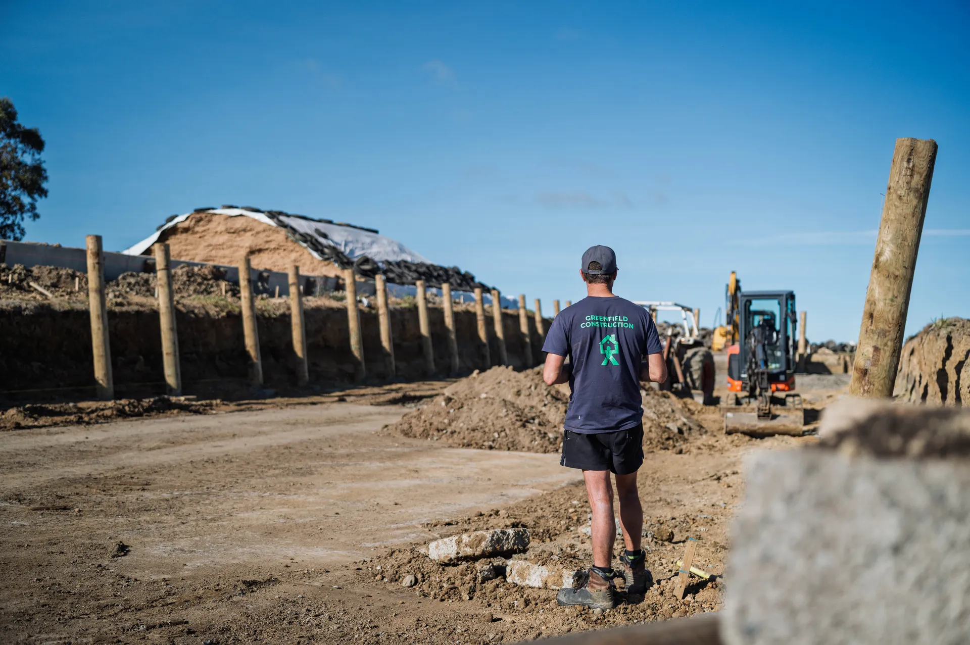 Builder from Greenfield Construction looking out to the construction site of a silage bunker on a rurla property