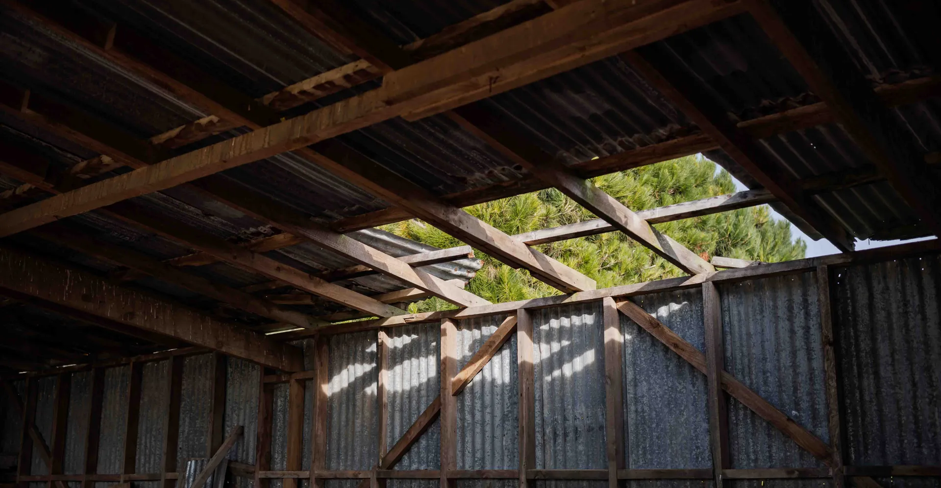Farm shed roof requiring repairs and upgrades on a rural property