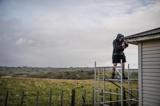 Builder standing on scaffolding working on a construction project in Feilding