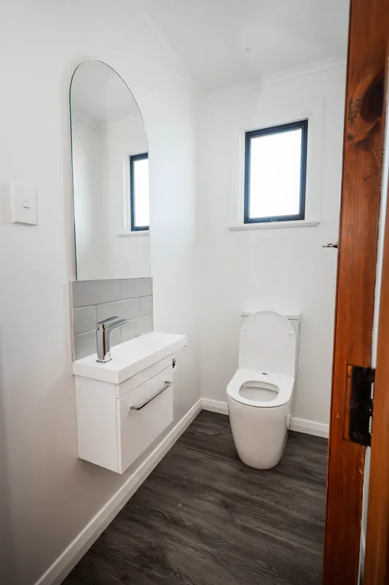 Toilet room repair, replacement of old toilet and renovation to room with new sink and toilet